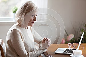 Thoughtful aged female considering something making decision photo