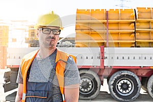 Thoughtful architect standing against truck at construction site
