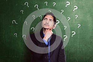 Thoughtful asian businessman having many questions in his head