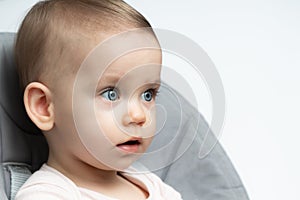 Thoughtful Baby in Highchair: Innocence and Depth. Concept of Childhood Contemplation