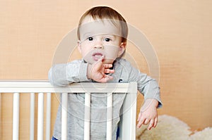 Thoughtful baby in white bed