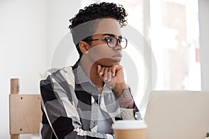 Thoughtful black female look in distance making decision photo