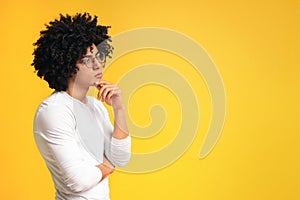 Thoughtful black man profile portrait on orange background