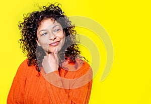 Thoughtful black woman face portrait isolated on yellow background