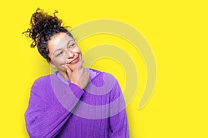 Thoughtful black woman face portrait isolated on yellow background
