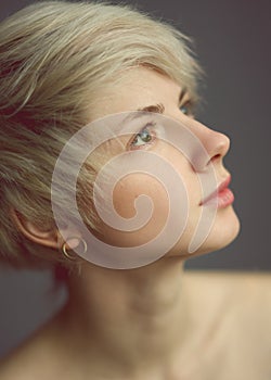 Thoughtful blond woman looking upward