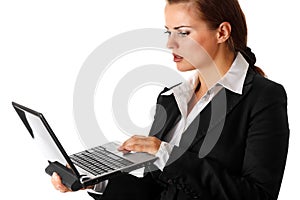 Thoughtful business woman looks in laptops screen