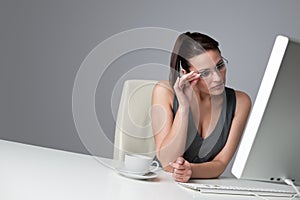 Thoughtful business woman at office with coffee