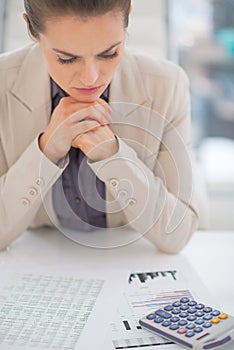 Thoughtful business woman working with documents