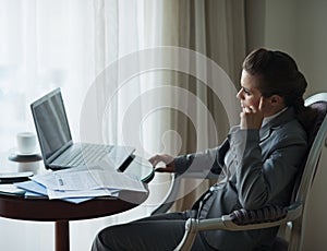 Thoughtful business woman working at hotel room