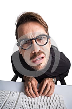 Thoughtful businessman with glasses using computer