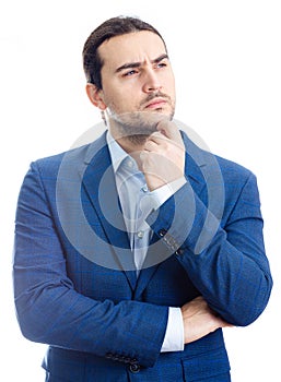 Thoughtful businessman keeps hand under chin, looking away  isolated on white background. Reflective business person planning and