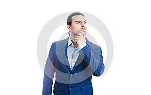 Thoughtful businessman keeps hand under chin, looking away pensive isolated on white background. Reflective business person