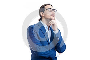 Thoughtful businessman keeps hand under chin, looking up pensive isolated on white background. Reflective business person planning