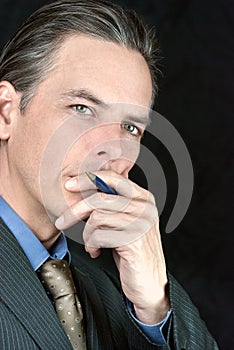 Thoughtful Businessman Looks To Camera