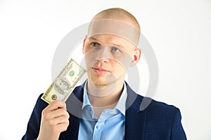 Thoughtful businessman in suit on white background holding cash. Thinking about making money.