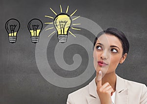 Thoughtful businesswoman against light bulbs on grey background