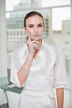 Thoughtful businesswoman looking at camera