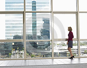 Thoughtful Businesswoman Looking Out Of Office