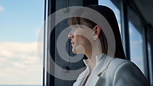 Thoughtful businesswoman looking window closeup. Successful ceo consider issues