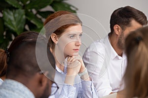 Thoughtful businesswoman thinking of business challenges opportunities at group meeting