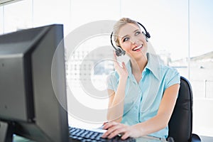 Thoughtful call centre agent working on computer