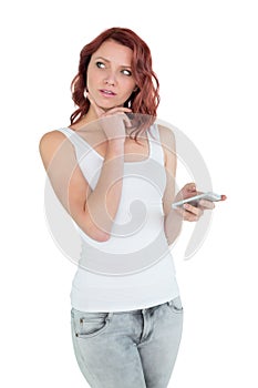 Thoughtful casual young woman with mobile phone