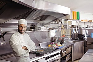 Thoughtful chef standing in commercial kitchen