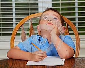 Thoughtful child doing his homework