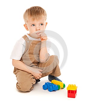 Thoughtful child playing with toys isolated