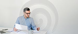 Thoughtful confident businessman checking working plan and schedule or timetable in office copy space