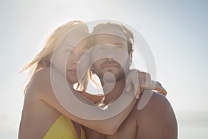 Thoughtful couple embracing at beach