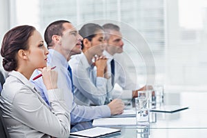 Thoughtful coworkers listening to presentation