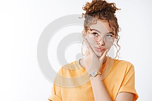 Thoughtful creative attractive redhead curly-haired female blogger thinking make-up new content ideas look focused take