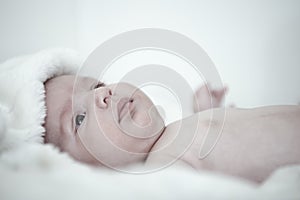 Thoughtful cute baby lies on back