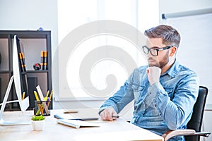 Thoughtful designer using graphic tablet and computer