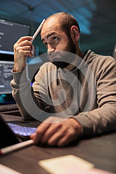 Thoughtful developer brainstorming ideas to find source code