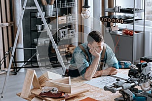 Thoughtful engineer sitting at desk photo