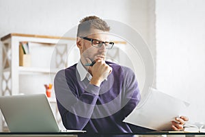 Thoughtful european businessman working on project