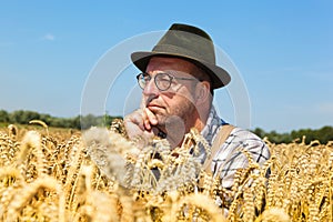 Thoughtful farmer in a corn field