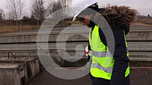 Thoughtful female inspector checking concrete blocks