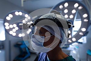 Thoughtful female surgeon standing in operation theater photo