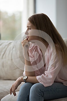 Thoughtful frustrated concerned 30s woman thinking over problems