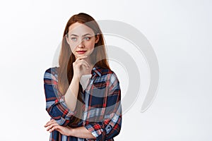 Thoughtful ginger girl with freckles, long natural hair, look left and thinking, ponder something, making choice photo