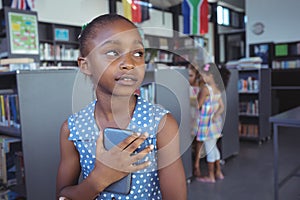 Thoughtful girl holding mobile phone