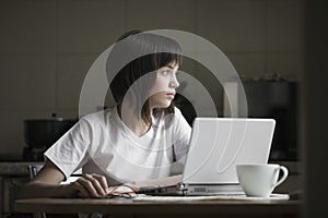 Thoughtful Girl With Laptop At Kitchen