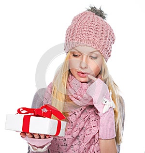 Thoughtful girl looking on christmas present box