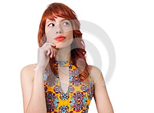 Thoughtful girl looks to the side. Young redhead woman with summer dress..