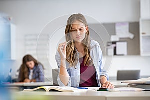 Thoughtful girl studying in high school