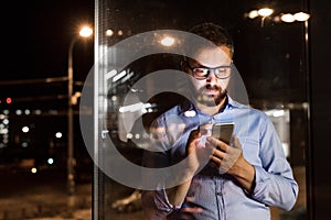 Businessman in the office at night working late.